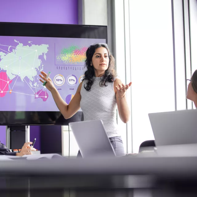 Woman presenting at a board meeting