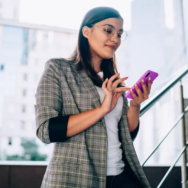 Woman smiling at phone